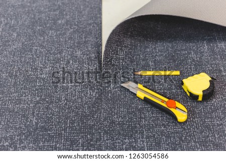 Work tools for laying carpet - tape measure, knife and pencil - laying flooring Royalty-Free Stock Photo #1263054586