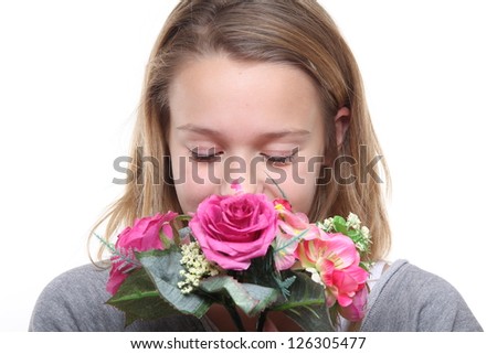 Beautiful blonde girl smelling flowers
