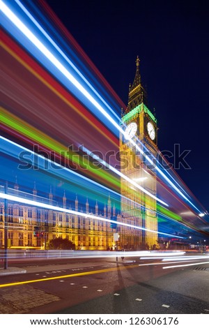 Big Ben in the evening. Dabldekker passes and leaves a line of light at slow shutter speeds. Cityscape shot with tilt-shift lens, the vertical lines of the object stored