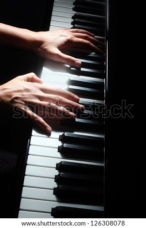 Piano music pianist hands playing. Musical instrument grand piano details with performer hand on black background