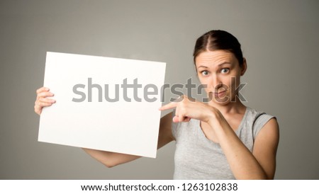 Smiling woman sign board holding. Girl showing banner with copy space
