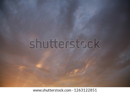 Beautiful clouds float across the blue sky. This background is illuminated by the natural light of heaven. Beautiful clouds and the sky are illuminated by bright light.