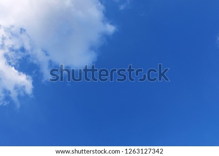 Beautiful white fluffy cloud on left top edge under deep blue sky. Amazing clear sky day for background. Copy space for text.