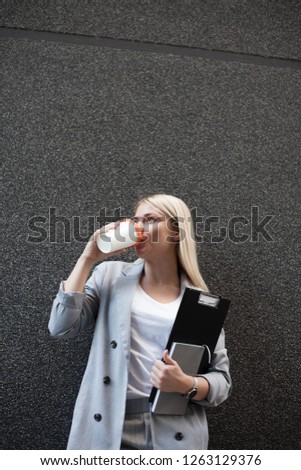 Businesswoman drinking coffee during break.