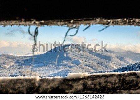 view from window on snowy winter mountains