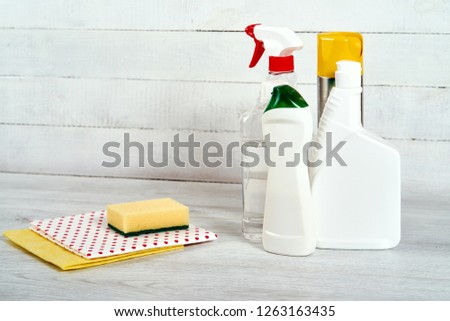 Cleaning set for different surfaces in kitchen, bathroom and other rooms with sponge and cloth on  wooden background