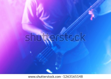 Background professional electronic guitar hero player strumming solo on stage in club, concert, music festival, new year party, air guitar competition. Play rock and teaching tutorial band perform