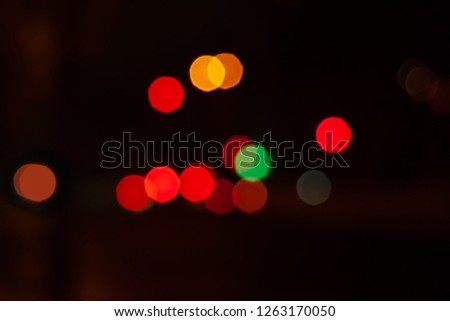 Blurred night background of city street road with bokeh effect. Abstract wallpaper for design and editing images.