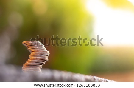 Coins stacked on table and natural background.