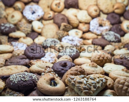 A lot of different cookies filling the whole picture, with different depth of field frame.