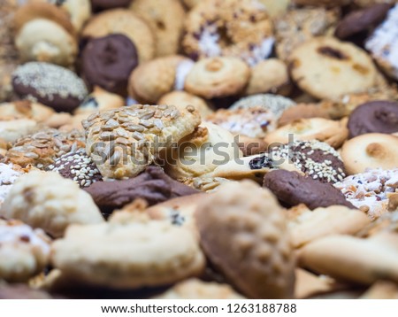 A lot of different cookies filling the whole picture, with different depth of field frame.