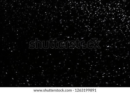 natural snow on black night background with selective focus