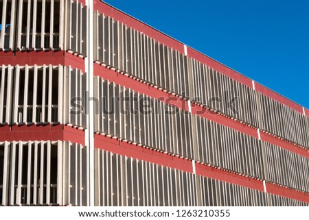 Retro red building wallpaper texture background shot against a blue sky.