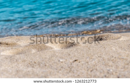 Yellow sand on the shore against the sea