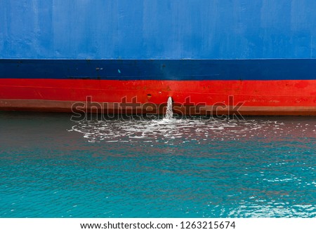 Bilge Pump.  Close-up of Bilge pump excreting water from Ship. The collected water must be pumped out to prevent the bilge from becoming too full and threatening to sink the ship.Stock Image. Royalty-Free Stock Photo #1263215674