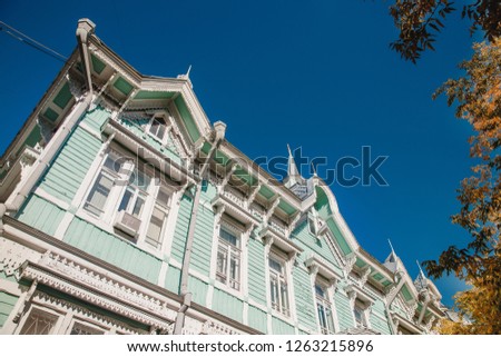 Wooden old house with carving against the blue sky, Tomsk, Russia.