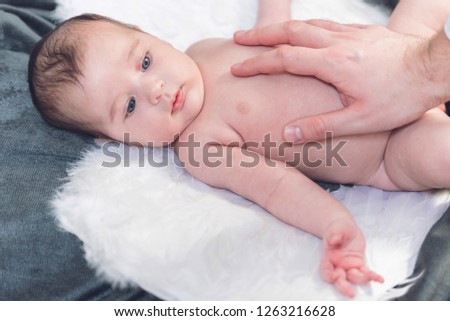 Closeup portrait of a cute tiny baby girl feeling safe and calm while her father is protecting her, Adorable family photography
