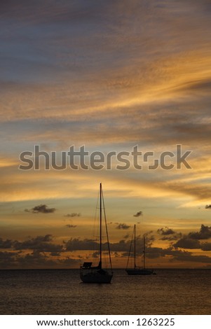 Colourful caribbean sunset with sailboats