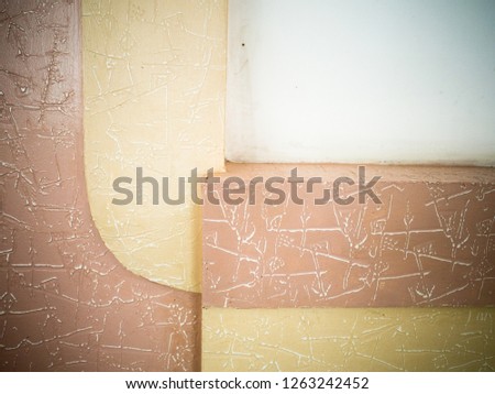 Graphic photo textured wall of yellow, pink and white colors.