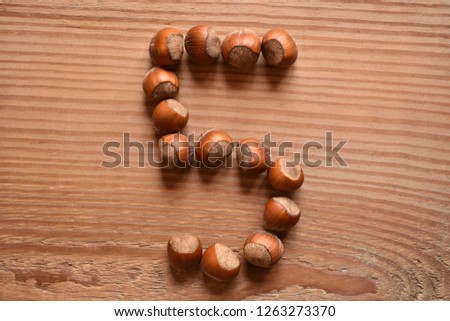 a horizontal of the number 5 shaped with hazelnuts