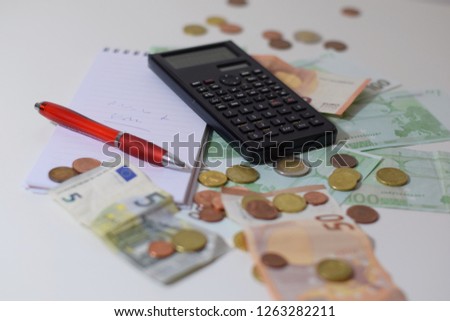 Euro notes and coins on a white table