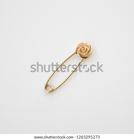 golden pin with flower, female accessory, golden brooch, female brooch on a white background