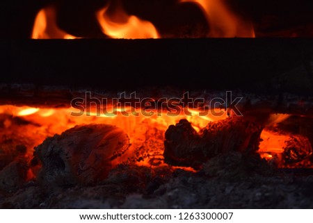 Close up of a bright red hot flame burning fire wood outdoors