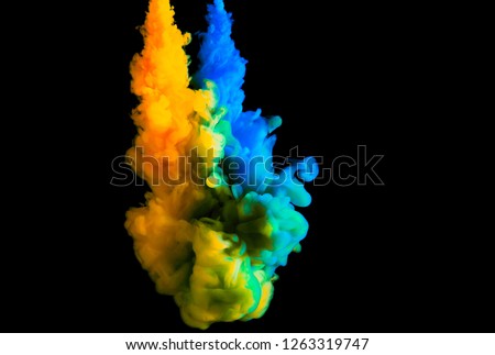 double paint stream in water, colored ink cloud, abstract background, process of mixing multicolored dye on a black background
