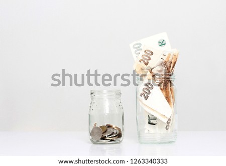money in a glass jar sitting on the table no people stock photo