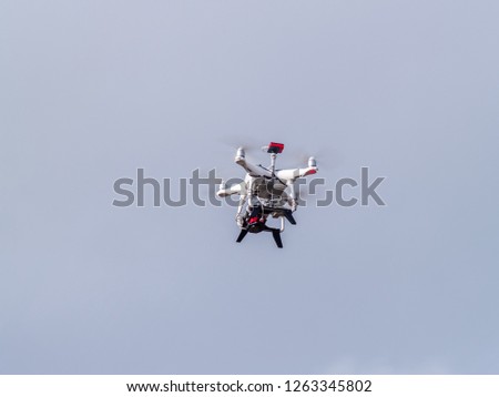 A drone in motion flying in the cloudy sky