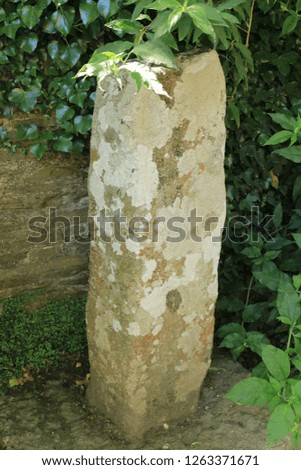 Roman limestone column in the countryside in Cornwall, England. A Roman column made of limestone in the countryside in Cornwall, England.