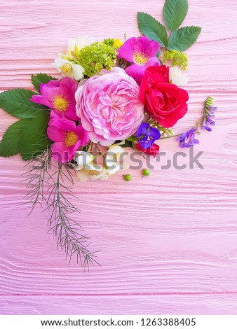 beautiful rose composition on a pink wooden background