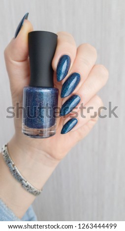 Female hands with long nails with blue nail polish
