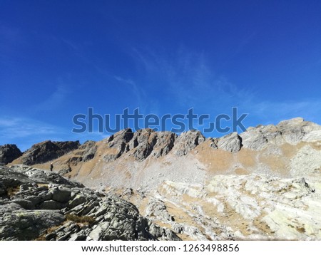 Val Bognanco, Piedmont, Italy, October 2018 - Landscape of some Italian Alpine Peaks with blue sky and some rocks in the foreground