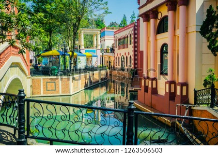 a corner city with european venice style building with river and bridge in indonesia Royalty-Free Stock Photo #1263506503