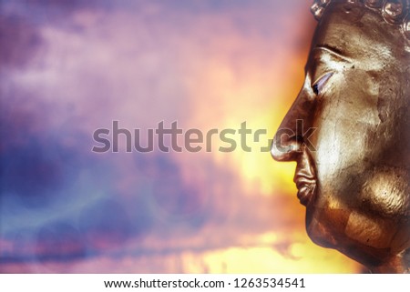 face of golden Buddha statue on abstract background