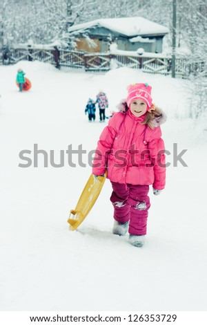 Happy girl in red clothes in winter outdoors