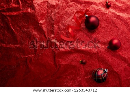 Christmas ornaments decorations background. Classic red and white glass baubles balls on red background. Flat lay, top view, copy space