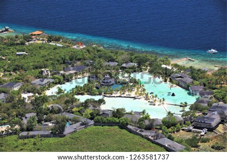 A view from the air of Plantation Bay Resort and Spa in Mactan Island, Philippines. Royalty-Free Stock Photo #1263581737