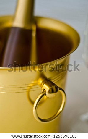 Beautiful dishes in the interior. Yellow or gold bucket and a container for cooling champagne and sparkling wine.