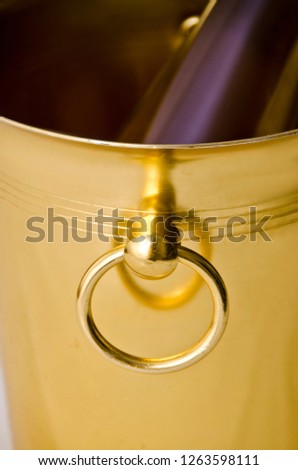 Beautiful dishes in the interior. Yellow or gold bucket and a container for cooling champagne and sparkling wine.