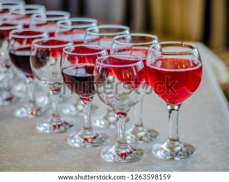 Beautiful dishes in the interior. Beautiful table setting with empty and full glasses of wine on a dark or light background in the interior of the cafe and restaurant.