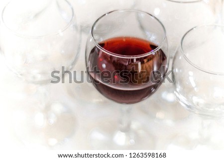 Beautiful dishes in the interior. Beautiful table setting with empty and full glasses of wine on a dark or light background in the interior of the cafe and restaurant.