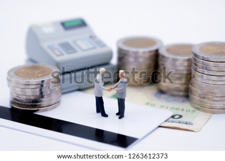 Miniature people : Business group standing on credit card with cashier machine and coins. picture use for background shopping business concept.