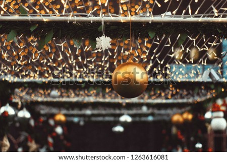 Christmas decoration bauble with blurry lights background in low light tone with copy space. Happy New year celebration in holiday.