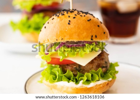 Delicious burgers with beef, tomato, cheese, french fries and lettuce. Copy space.