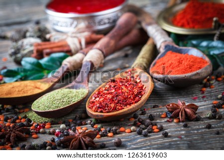 Spices and seasonings on the kitchen table on the old background