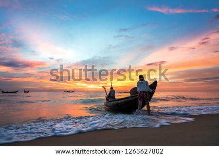 white beach with long tail boats of fisherman in dawn summer of tropical in Vinh Thanh, Hue, Vietnam.