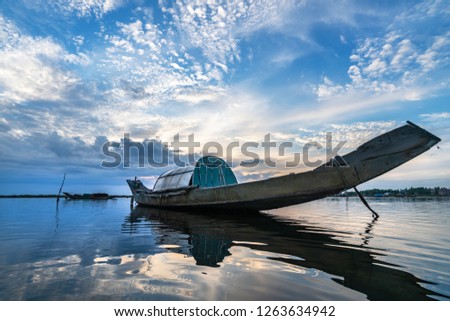 White beach with long tail boats of fisherman in summer of tropical in Quang Loi, Hue, Vietnam. Tam Giang lagoon