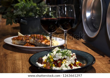 Romantic dinner for two in a restaurant. Served table with glasses of wine and plates of meal.